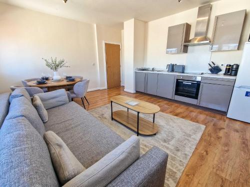 a living room with a couch and a table at Free Parking City Centre Flat by City SuperHost in Manchester