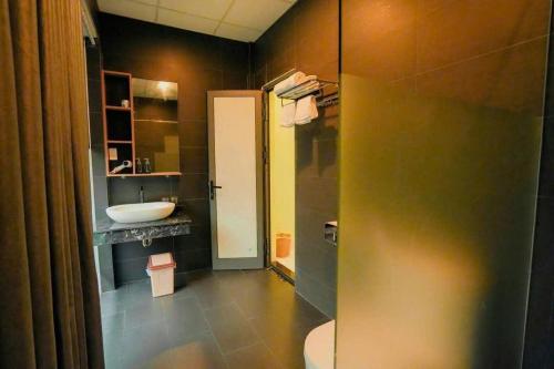 a bathroom with a sink and a toilet at Hy Viên boutique Garden & Swimming pool in Cồn Giả Viên