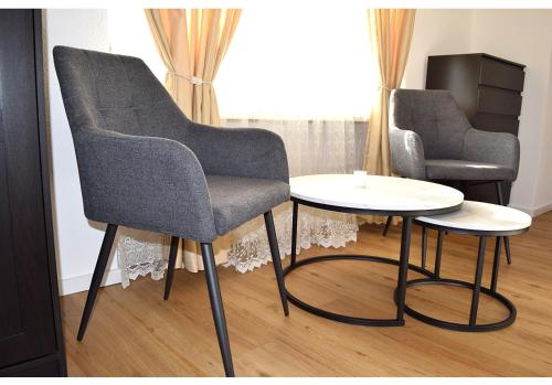 a chair and a table in a room at Hotel Restaurant Krebs in Grenchen
