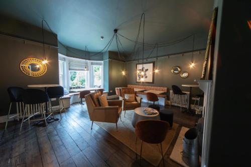a living room with chairs and a couch and a table at Blakeney House in Blakeney