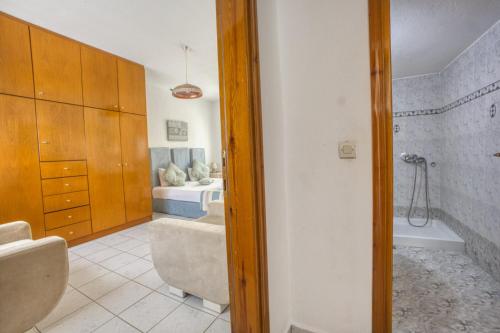 a bathroom with a bath tub and a sink at Maison Ciel in Agia Paraskevi