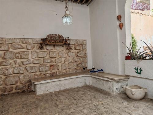 a room with a stone wall and a bench at Casa Gelsomino by Holiday World in Donnalucata