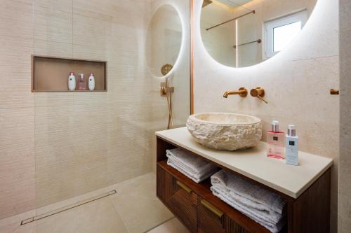 a bathroom with a sink and a mirror at Beach villa with ocean view and rooftop cinema in Guia