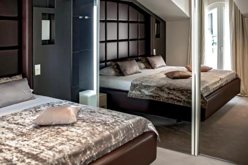 a bedroom with two beds and a mirror at Damianii Luxury Boutique Hotel & Spa in Omiš