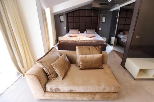 a bedroom with two beds and a couch and a bed at Damianii Luxury Boutique Hotel & Spa in Omiš