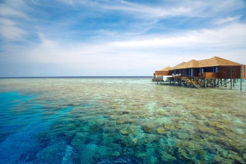 a house on a pier over the water at Lily Beach Resort and Spa - All Inclusive in Dhangethi