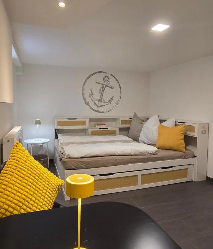 a bedroom with a large bed with yellow pillows at Ankerplatz in Lindau