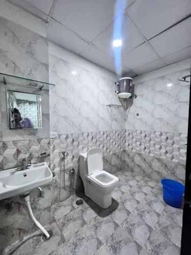 a bathroom with a toilet and a sink at Hotel Airport residency in Jaipur