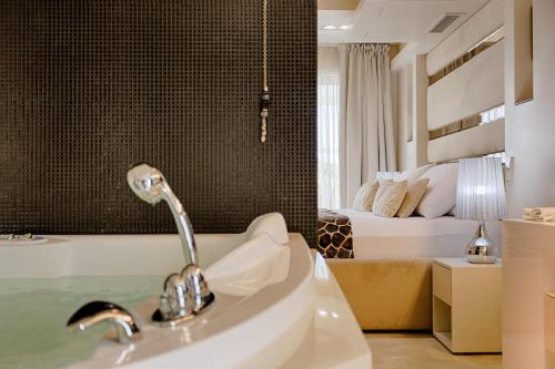 a bathroom with a sink and a bed at Damianii Luxury Boutique Hotel & Spa in Omiš