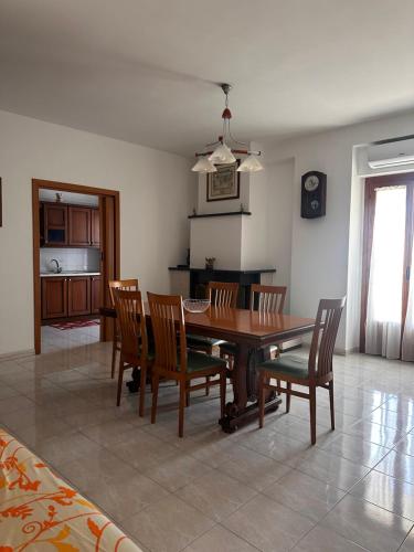 a dining room with a wooden table and chairs at Casa del Cuore Vieste in Vieste