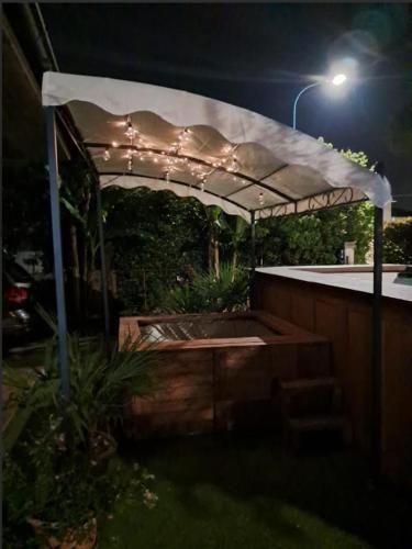 a white canopy over a hot tub at night at Sakura B&B Franciacorta in Cologne