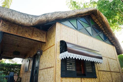 a tree growing on top of a house at Ilocos Urban Wave Resort in Laoag