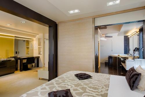 a bedroom with a bed and a bathroom at Damianii Luxury Boutique Hotel & Spa in Omiš