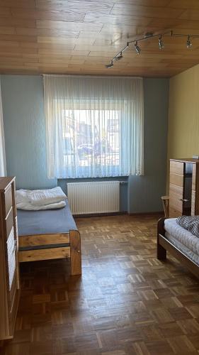a bedroom with two beds and a window at Schöne Monteur- Wohnungen teilweise mit Balkon oder Terrasse in Ahlen