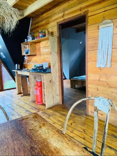 a wooden cabin with a counter and a chair in a room at michamvi mangrove cabin in Michamvi