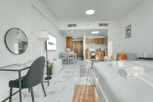 a hotel room with a large bed and a desk and chair at Chic Studio with Lagoon Views Walk Beach and Golf in Ras al Khaimah