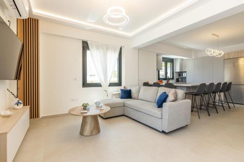 a living room with a couch and a table at Villa Bianca with Jacuzzi in Gouves