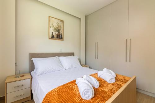 a bedroom with a bed with towels on it at Villa Bianca with Jacuzzi in Gouves