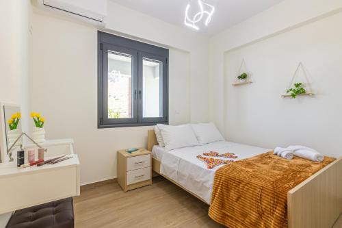 a bedroom with a bed and a desk and a window at Villa Bianca with Jacuzzi in Gouves
