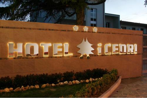a hotel sign in front of a building at Hotel I Cedri in Scandicci