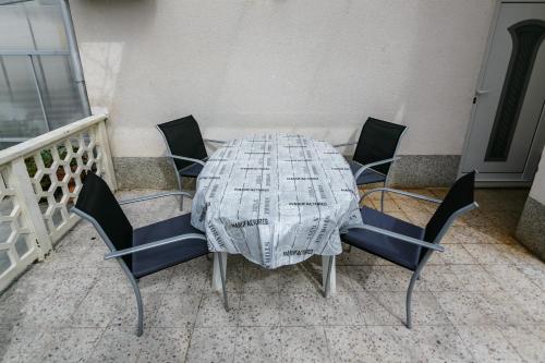 a dining room table with chairs at Apartmani Cvelic in Malinska