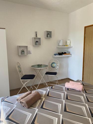 a room with a floor with a table and chairs at Room Josip in Senj
