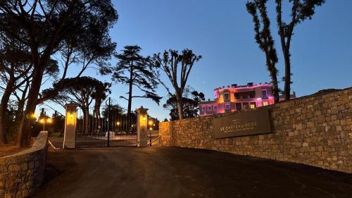 a house with a gate in front of a fence at Château Rose Golfe de Saint Tropez-Grimaud in Grimaud