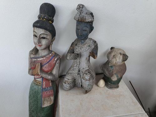 three statues of children and a teddy bear on a table at large jacuzzi and charming home center of old city in Chiang Mai