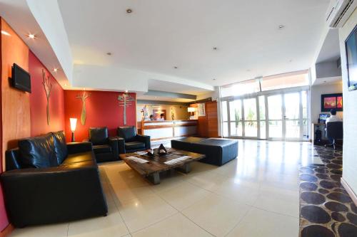 a living room with couches and a coffee table at La Mision Posadas in Posadas