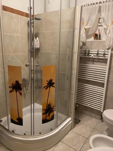 a bathroom with a shower with palm trees painted on it at Room Josip in Senj