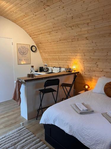 a bedroom with a bed and a sink in a room at Luxurious Tiny House with HotTub in Rijsenhout
