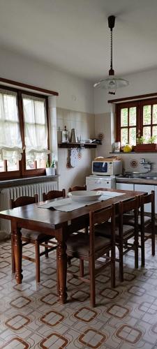 a kitchen with wooden tables and chairs in it at La Ginestra in Cavaglià