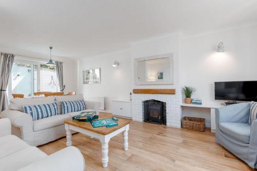 a living room with a couch and a fireplace at Lulwind in Lulworth Cove