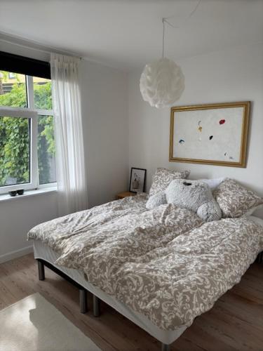 a bedroom with a bed and a window at Garden Apartment by the Sea in Sønderborg