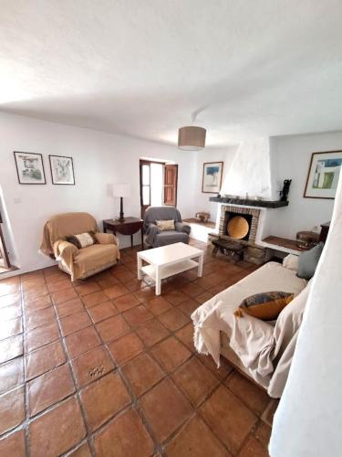 a living room with a couch and a fireplace at Casa Sinclair in Gaucín