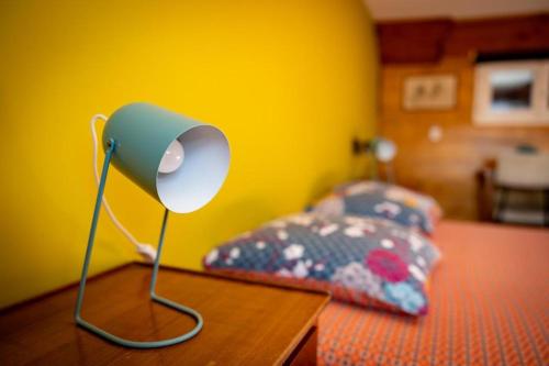 a lamp on a table next to a bed at Superbe Péniche En Centre Ville in Bordeaux