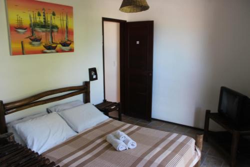 a bedroom with a bed with towels on it at Apart Hotel Casa Grande in Natal
