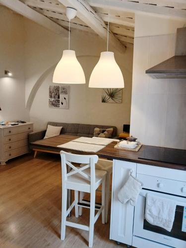 a kitchen with a table and chairs and two lights at Casa do Contreyras in Évora