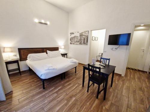 a bedroom with a bed and a table and chairs at La Ca' di sogn in Pavia