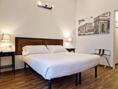 a bedroom with a large bed with white sheets at La Ca' di sogn in Pavia