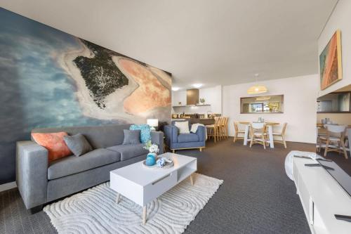 a living room with a couch and a table at Stylish 2-Bedroom Apartment in the Heart of Perth in Perth