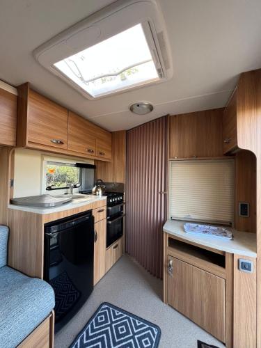 a kitchen with wooden cabinets and a skylight at Seaview Retreat & Sauna at An Acre By The Sea in Clonakilty