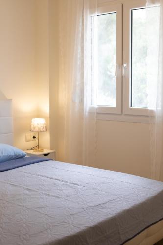 a bedroom with a bed and a window at Eukalyptos 3BD apartment with yard in Chersonisos in Hersonissos