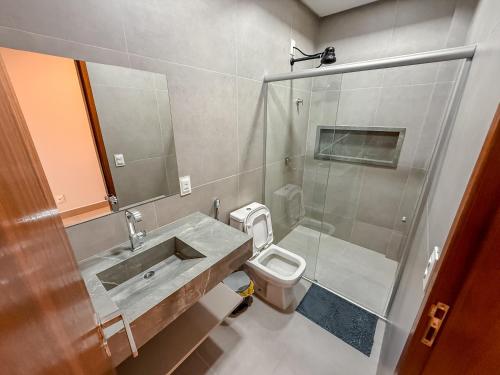 a bathroom with a sink and a toilet and a shower at Luxuosa Casa em Bananeiras in Bananeiras