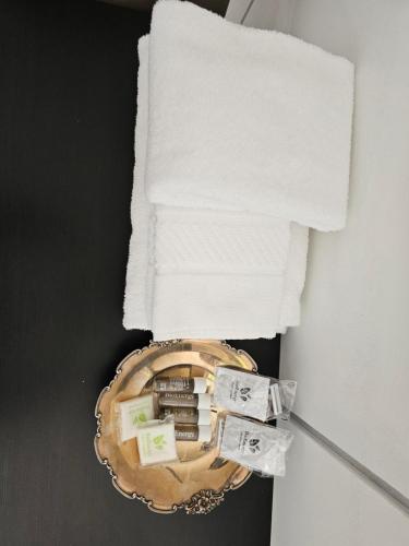a basket with towels on top of a bathroom at Victoria Royal Garden in Como