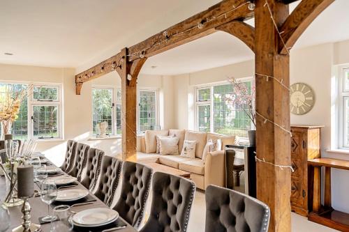 a dining room with a long table and chairs at Finest Retreats - The Old Rectory in Tring