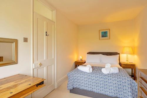 a bedroom with a bed with two towels at Finest Retreats - The Old Rectory in Tring