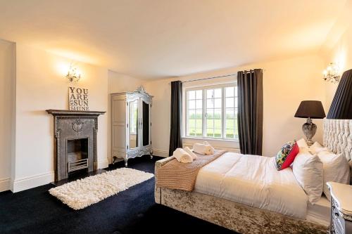 a bedroom with a bed and a fireplace at Finest Retreats - The Old Rectory in Tring