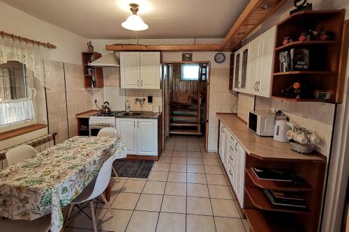 a small kitchen with a table and a counter top at Agroturystyka Pod Olchami in Lipowiec