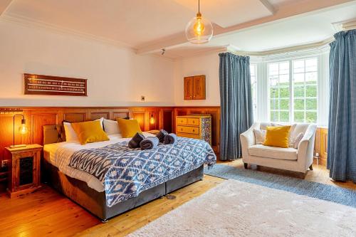 a bedroom with a bed and a chair at Finest Retreats - The Old Rectory in Tring